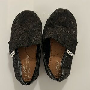 Worn once Toms sparkly black classic slip ons, size 6 little kid